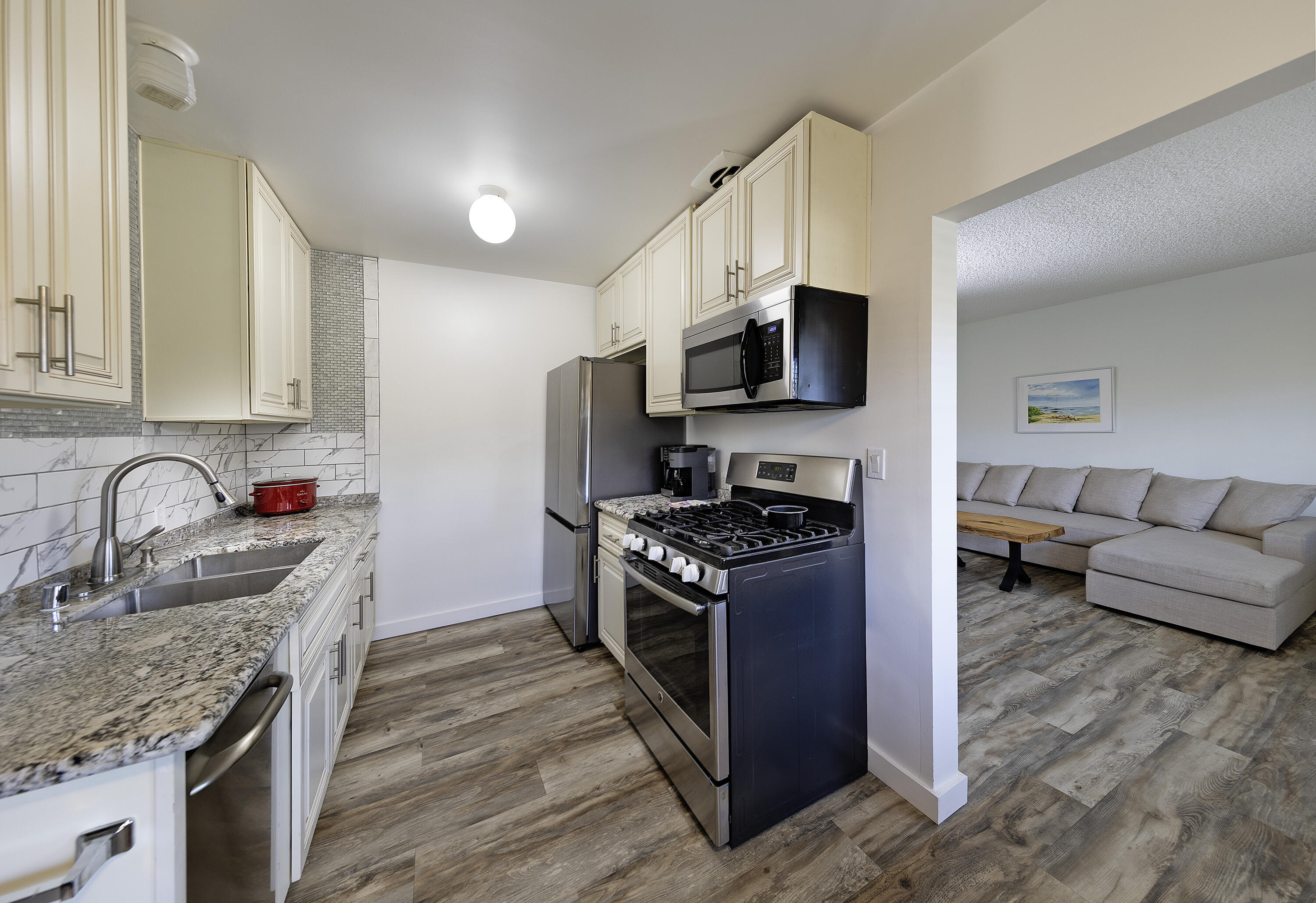 4980 Sandyland Road, Unit 203 Carpinteria, CA 93013 - Photo 4 of 23 a kitchen with stainless steel appliances granite countertop a sink stove and refrigerator
