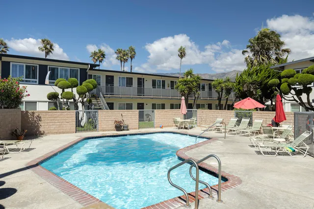 a view of a house with swimming pool and sitting area
