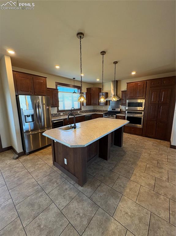 1925 Doe Valley Road Guffey, CO 80820 - Photo 17 of 30 a large kitchen with kitchen island a stove a sink a counter space and cabinets