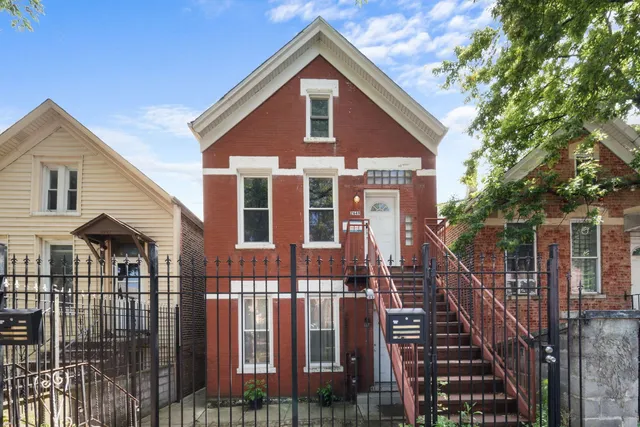 a view of a house with wooden fence and windows