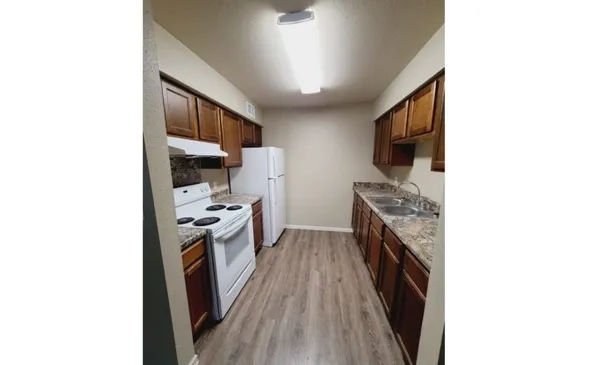 a kitchen with granite countertop a sink and steel appliances