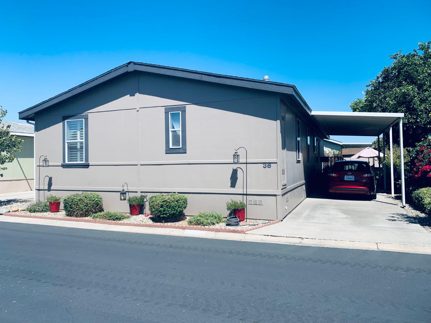 3901 Lake Road, Unit 36 West Sacramento, CA 95691 - Photo 1 of 1 a front view of a house with a yard and garage