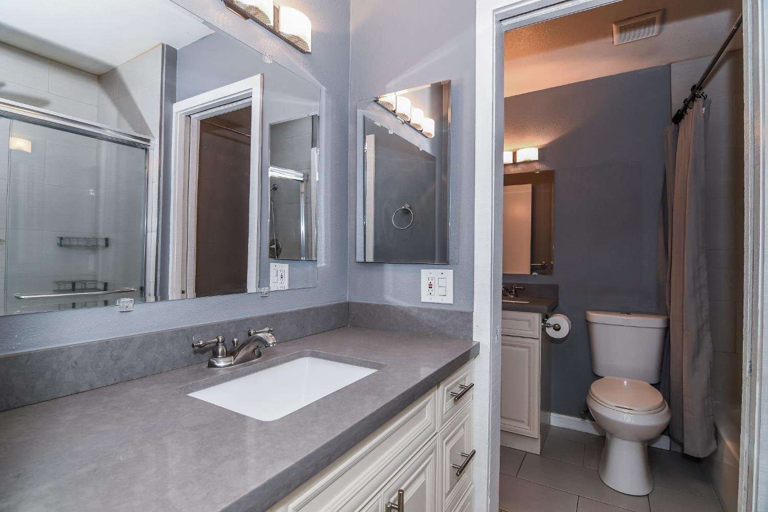 1139 Rivara Circle Sacramento, CA 95864 - Photo 49 of 72 a bathroom with a granite countertop sink toilet and mirror