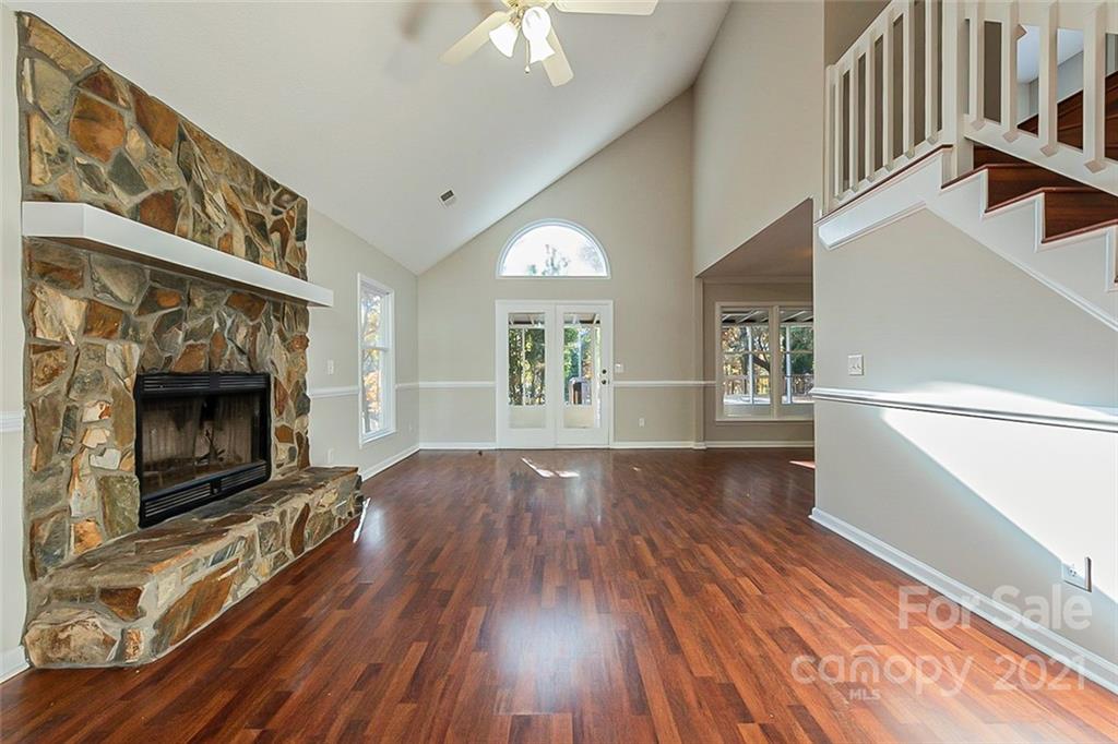 4059 Point Clear Drive Tega Cay, SC 29708 - Photo 2 of 16 a view of an empty room with wooden floor fireplace and a window