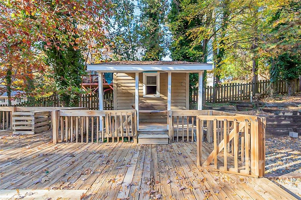4059 Point Clear Drive Tega Cay, SC 29708 - Photo 13 of 16 a view of a wooden deck and a yard with large trees