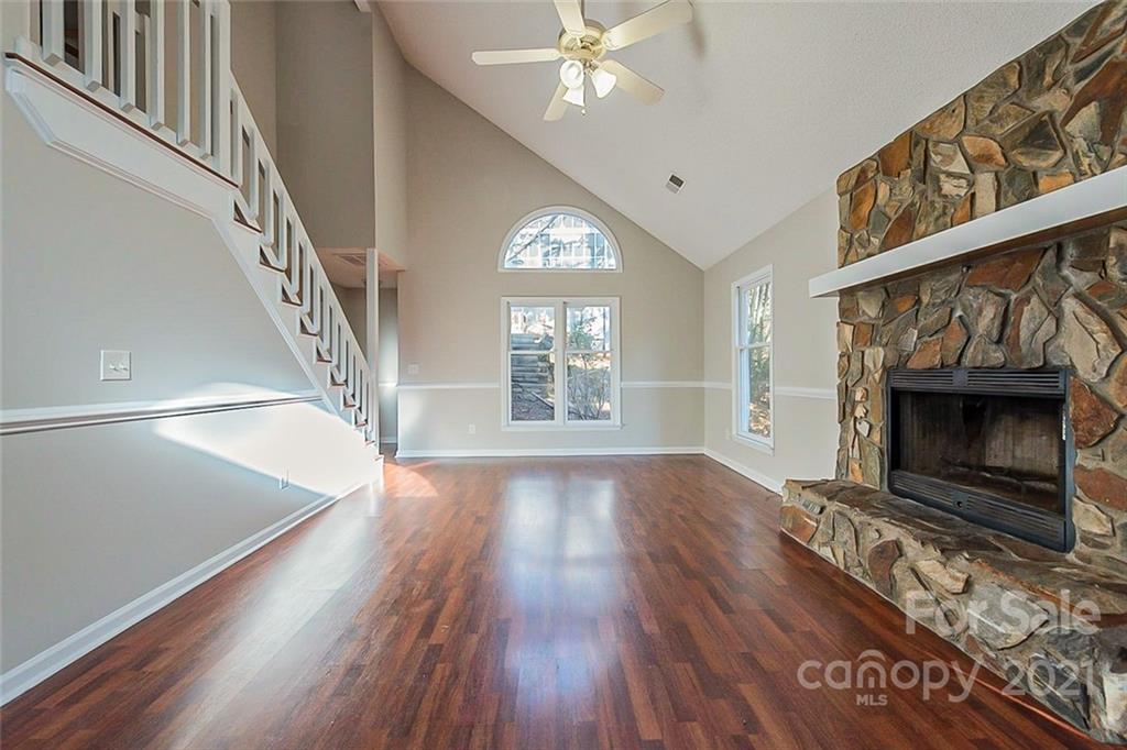 4059 Point Clear Drive Tega Cay, SC 29708 - Photo 3 of 16 a view of an empty room with wooden floor fireplace and a window