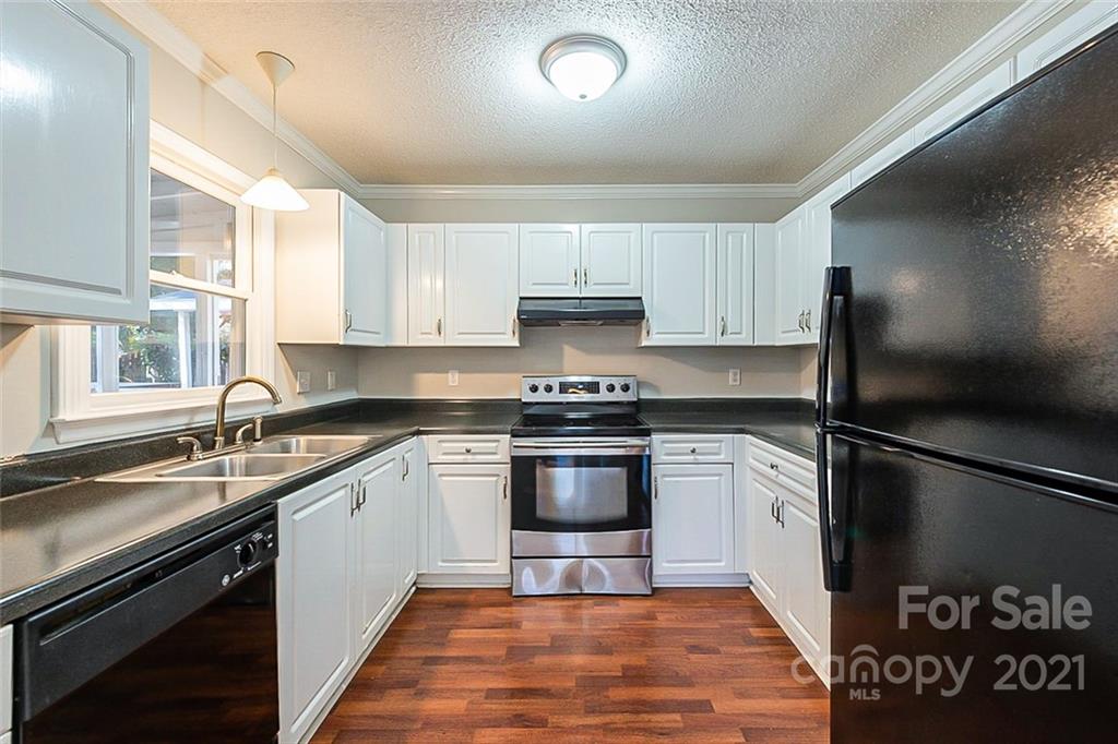 4059 Point Clear Drive Tega Cay, SC 29708 - Photo 4 of 16 a kitchen with a sink stove and refrigerator
