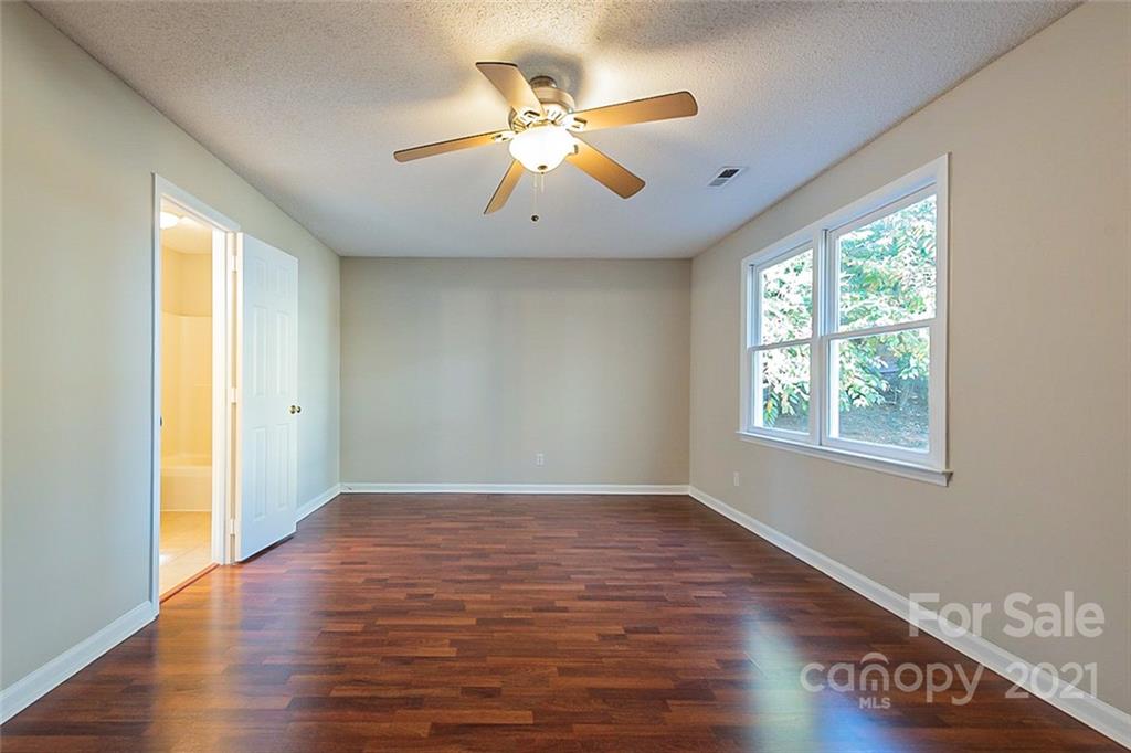 4059 Point Clear Drive Tega Cay, SC 29708 - Photo 6 of 16 a view of an empty room with wooden floor and a window