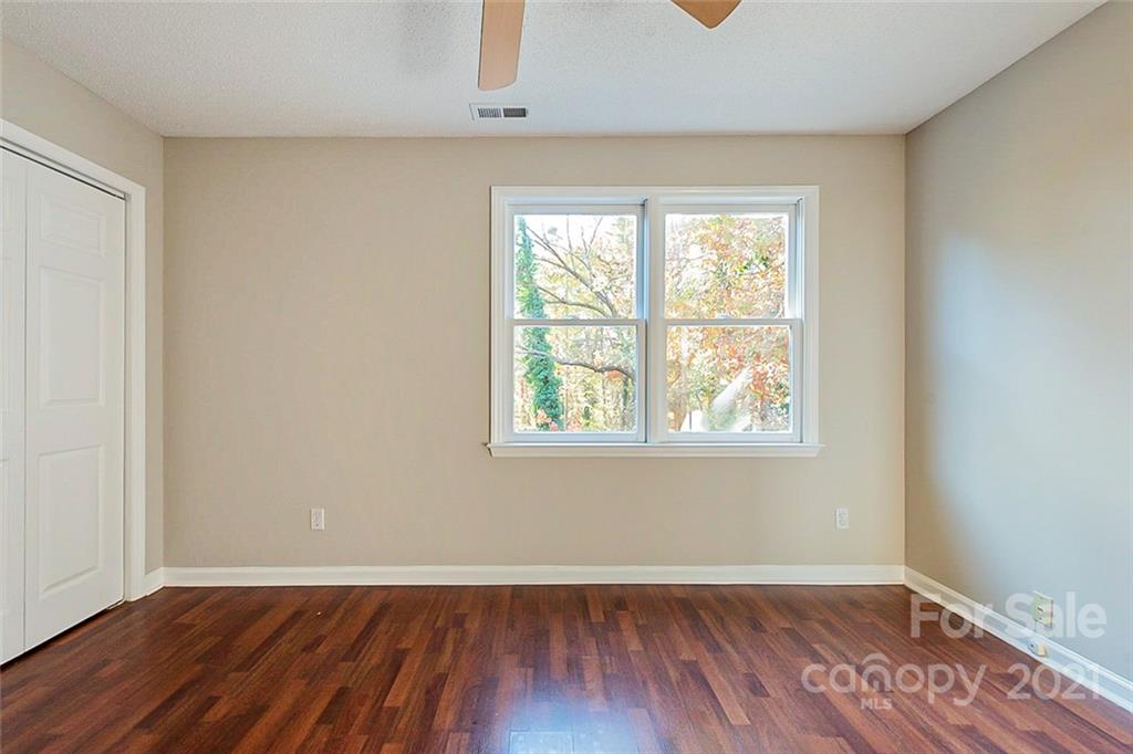4059 Point Clear Drive Tega Cay, SC 29708 - Photo 7 of 16 an empty room with wooden floor and windows
