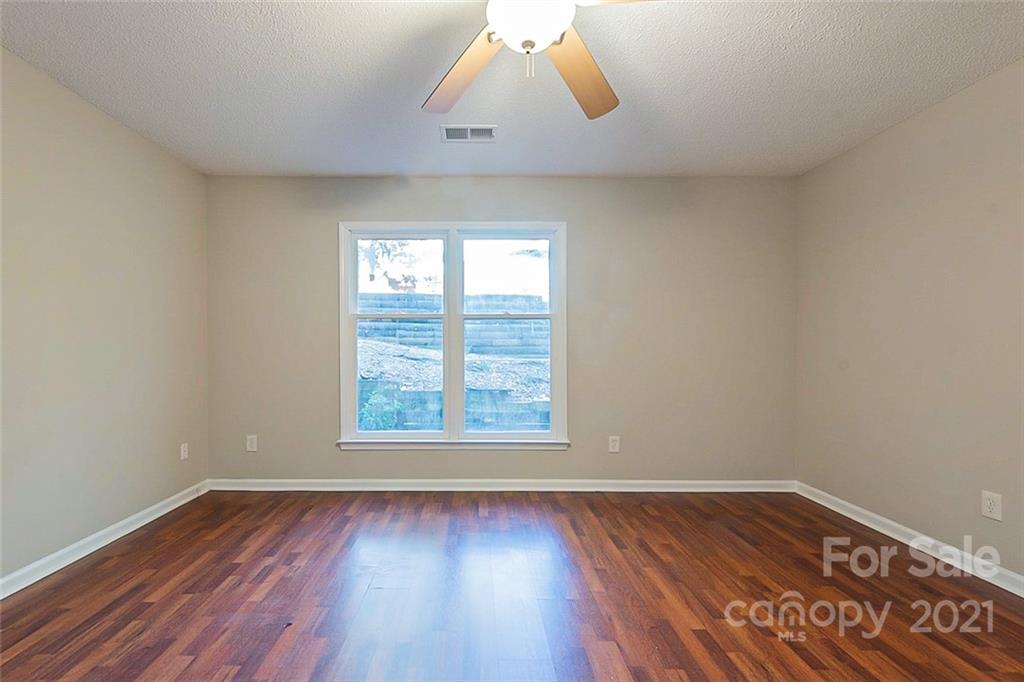4059 Point Clear Drive Tega Cay, SC 29708 - Photo 8 of 16 an empty room with wooden floor and windows