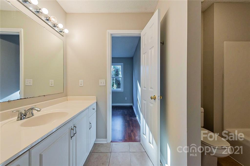 4059 Point Clear Drive Tega Cay, SC 29708 - Photo 9 of 16 a spacious bathroom with a double vanity sink and a mirror