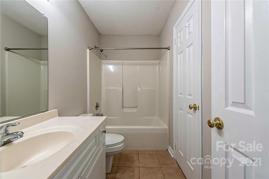 4059 Point Clear Drive Tega Cay, SC 29708 - Photo 10 of 16 a bathroom with a sink a toilet and shower