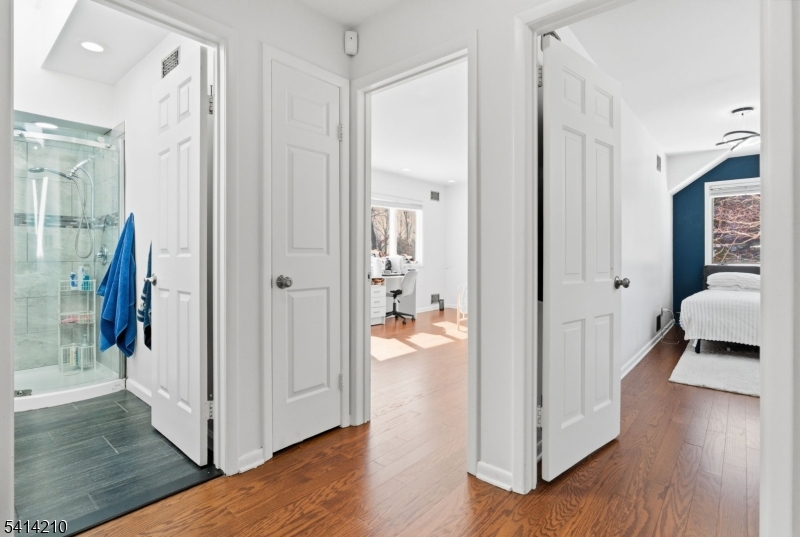 7 Post House Road Morristown, NJ 07960 - Photo 25 of 50 a view of a hallway with wooden floor and a living room