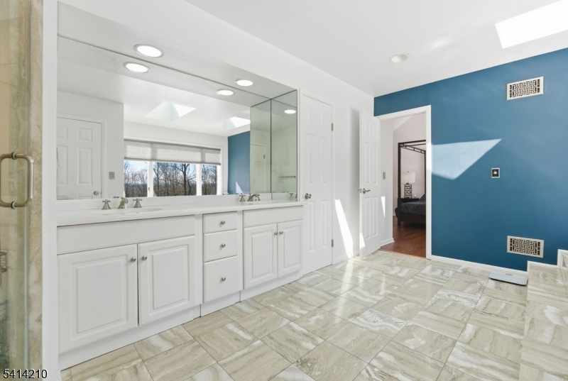 7 Post House Road Morristown, NJ 07960 - Photo 31 of 50 a spacious bathroom with a shower sink and mirror