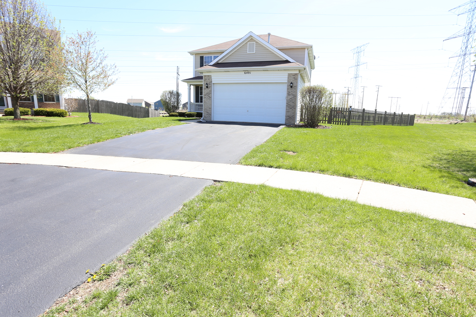 6401 Roth Court Joliet, IL 60431 - Photo 2 of 30 a view of a house with a yard and garage