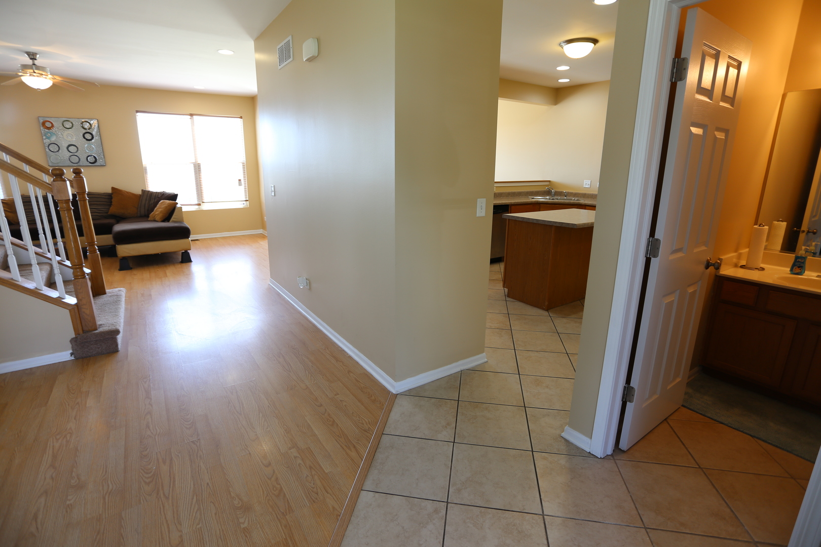 6401 Roth Court Joliet, IL 60431 - Photo 4 of 30 a view of a hallway and wooden floor and a livingroom with furniture