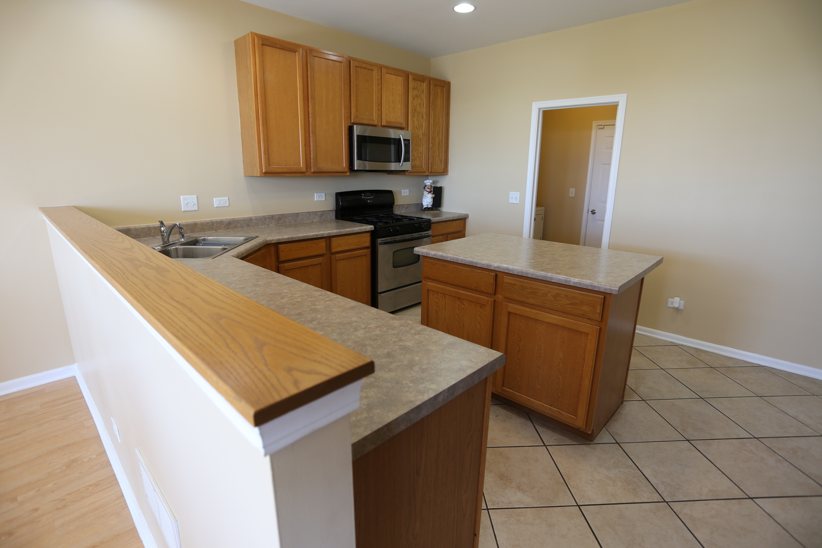 6401 Roth Court Joliet, IL 60431 - Photo 8 of 30 a kitchen with stainless steel appliances a sink a stove top oven a counter space and cabinets
