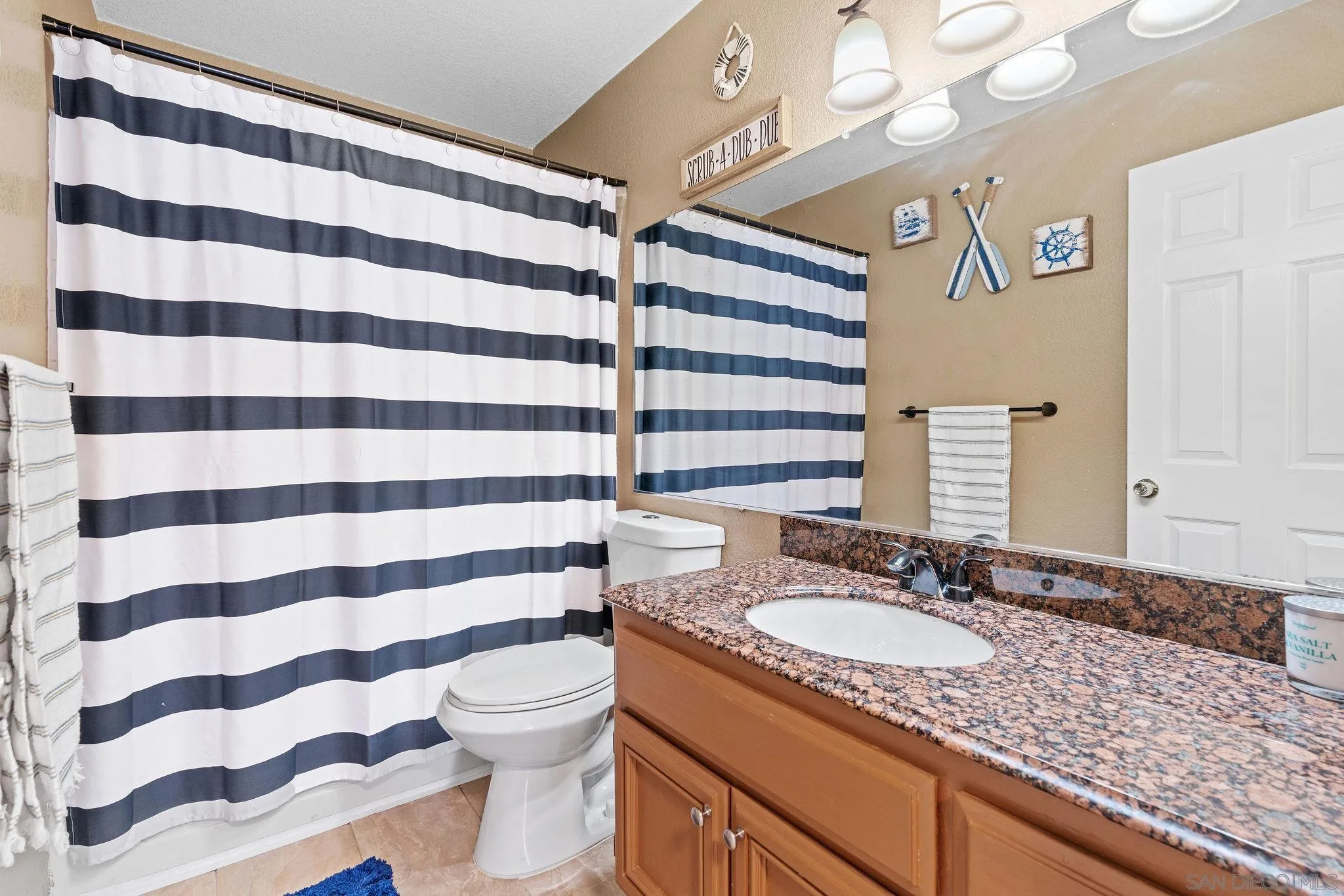 30239 Silver Ridge Court Temecula, CA 92591 - Photo 18 of 26 a bathroom with a granite countertop sink and a mirror