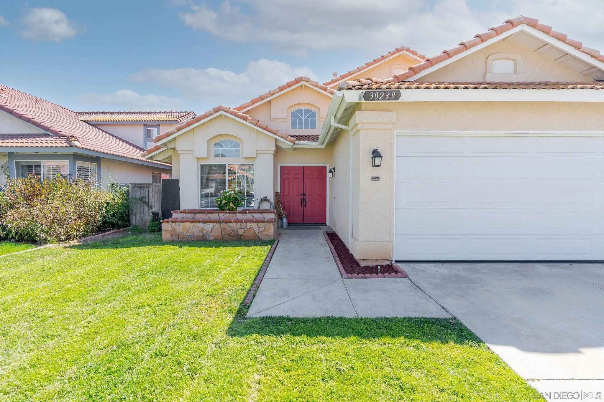 30239 Silver Ridge Court Temecula, CA 92591 - Photo 3 of 26 a front view of a house with a yard and garage