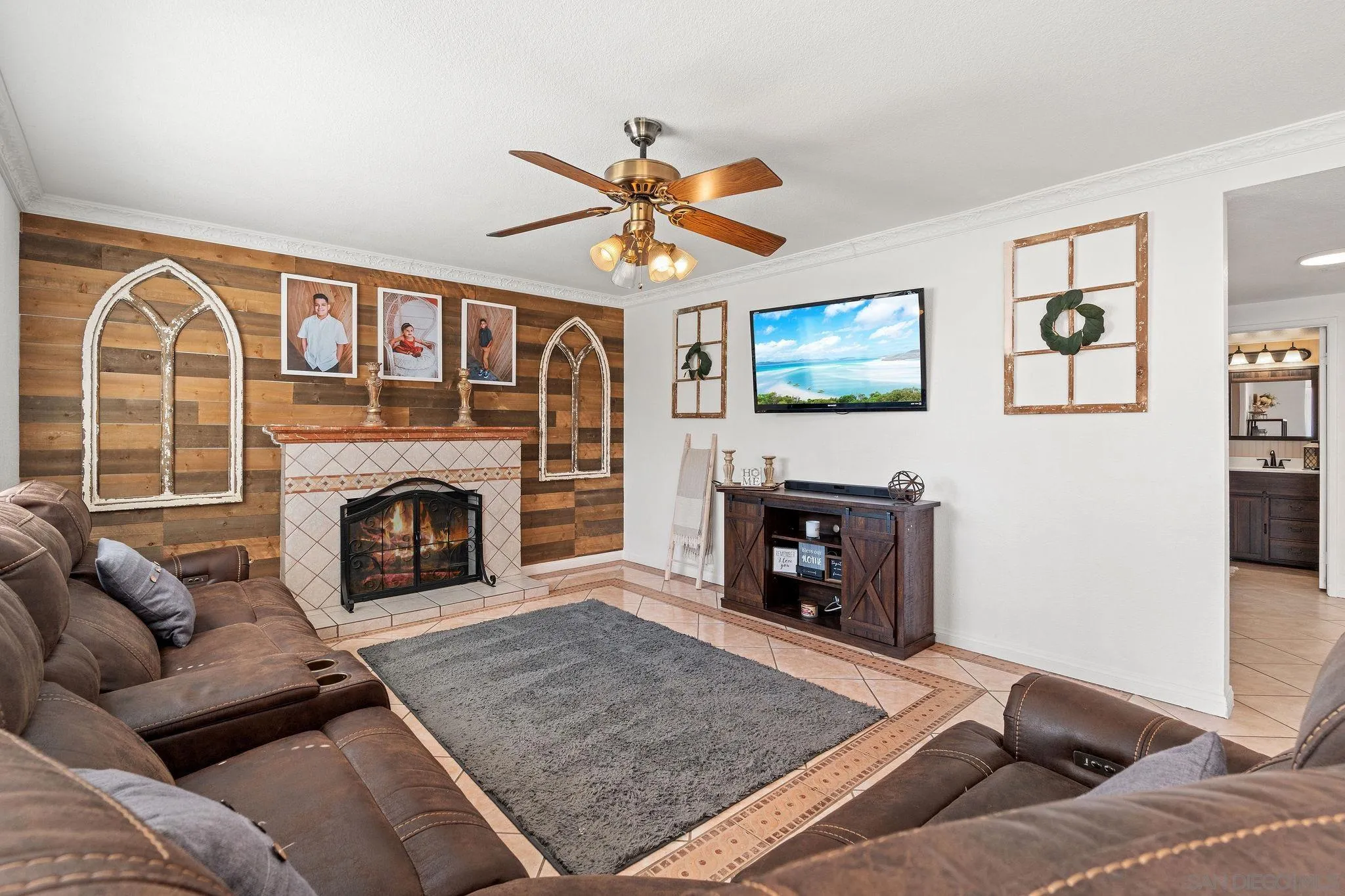 30239 Silver Ridge Court Temecula, CA 92591 - Photo 8 of 26 a living room with furniture a flat screen tv and a fireplace