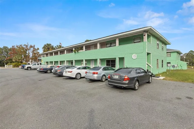 a couple of cars parked in front of a house