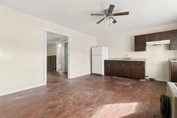 a workspace with a ceiling fan and a living room