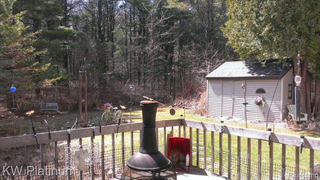 7230 Harrington Road Lexington, MI 48450 - Photo 7 of 46 Ext deck lower level facing woods.jpg