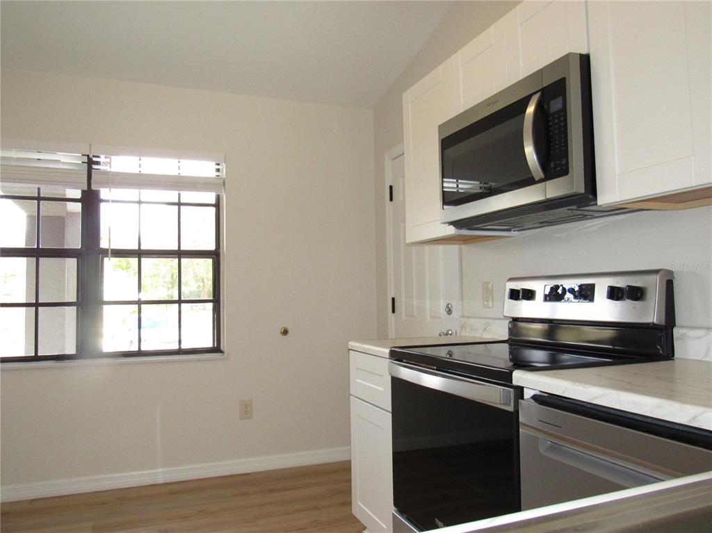 20005 Goldcup Court Port Charlotte, FL 33952 - Photo 12 of 33 a kitchen with a microwave and a microwave
