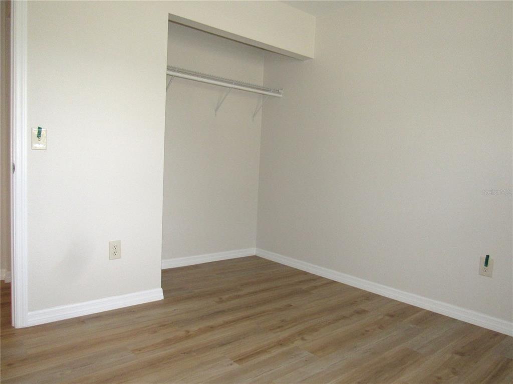 20005 Goldcup Court Port Charlotte, FL 33952 - Photo 16 of 33 a view of an empty room with wooden floor