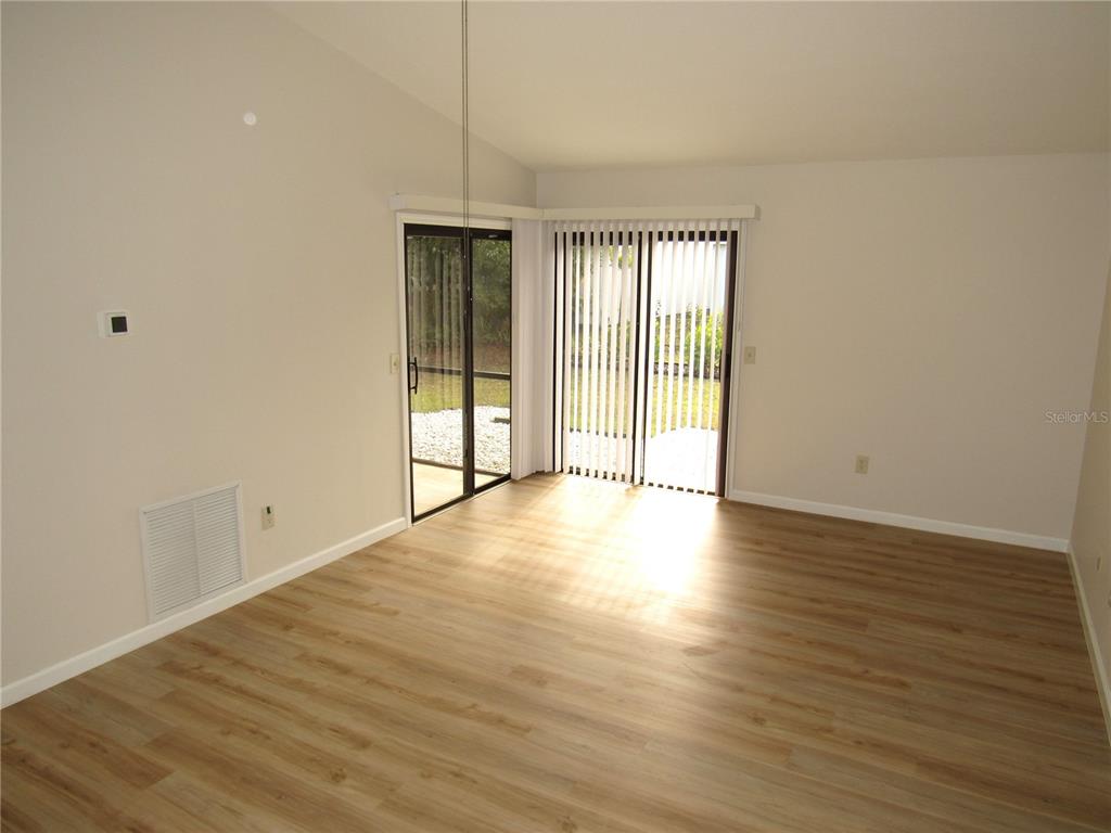 20005 Goldcup Court Port Charlotte, FL 33952 - Photo 6 of 33 a view of an empty room with wooden floor and a window