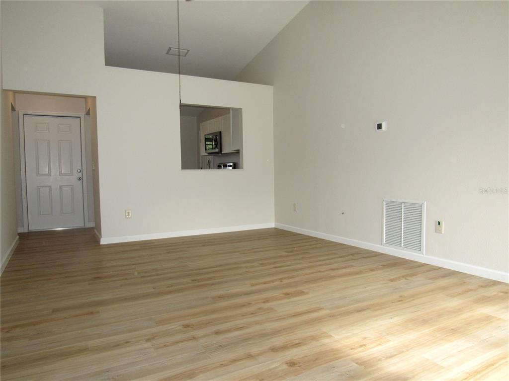 20005 Goldcup Court Port Charlotte, FL 33952 - Photo 7 of 33 a view of an empty room with wooden floor