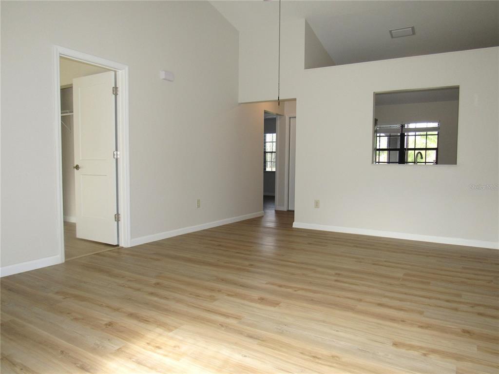 20005 Goldcup Court Port Charlotte, FL 33952 - Photo 8 of 33 a view of an empty room with wooden floor and a window