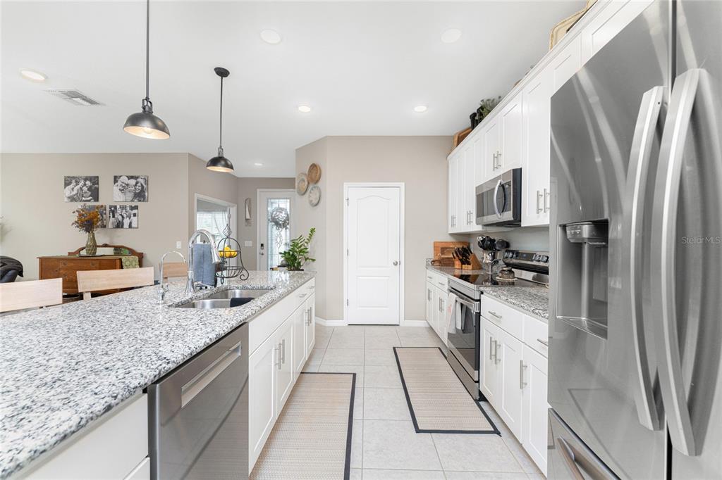 25381 Rupert Road Punta Gorda, FL 33983 - Photo 13 of 58 a large kitchen with stainless steel appliances granite countertop a sink a stove and a refrigerator