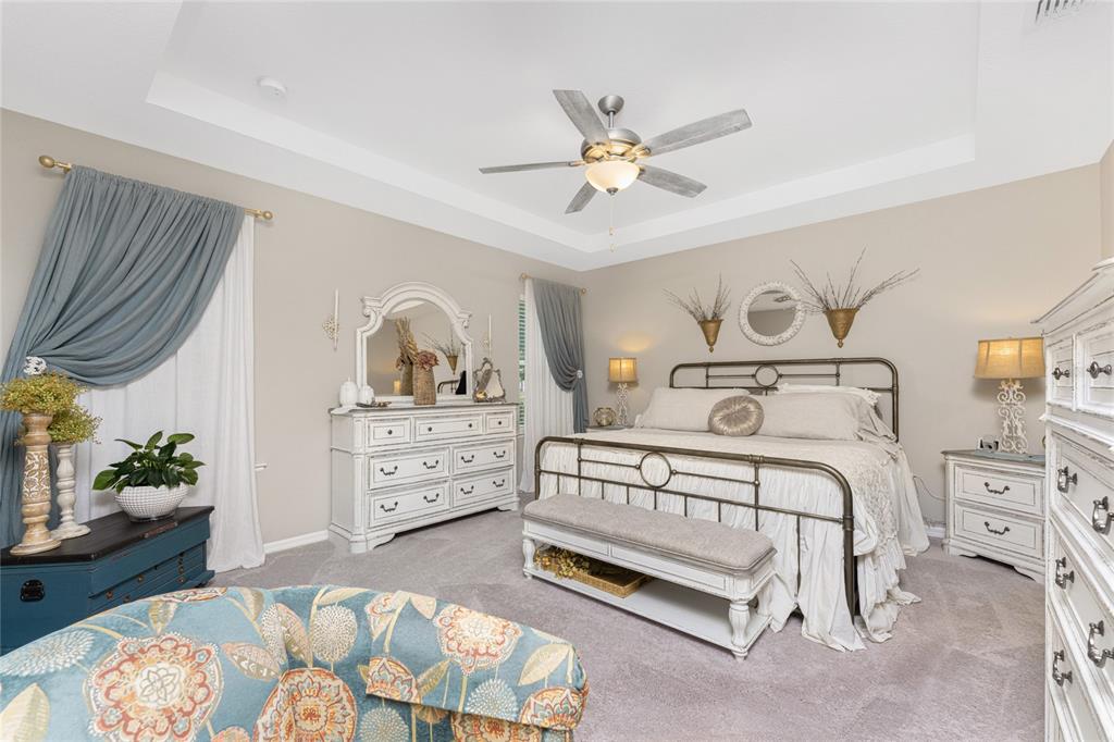 25381 Rupert Road Punta Gorda, FL 33983 - Photo 22 of 58 a bedroom with a bed and a chandelier