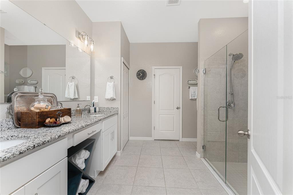 25381 Rupert Road Punta Gorda, FL 33983 - Photo 25 of 58 a spacious bathroom with a granite countertop sink a mirror and shower