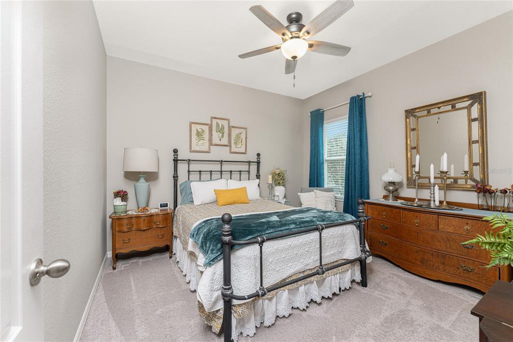 25381 Rupert Road Punta Gorda, FL 33983 - Photo 28 of 58 a bedroom with a bed and a chandelier