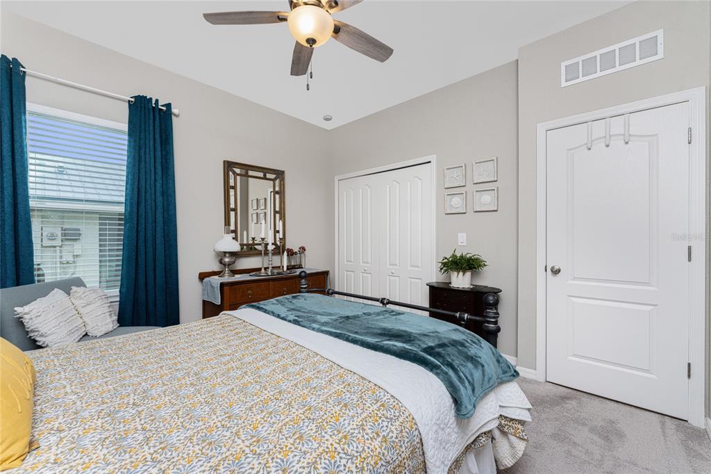 25381 Rupert Road Punta Gorda, FL 33983 - Photo 29 of 58 a bedroom with a bed and a chandelier