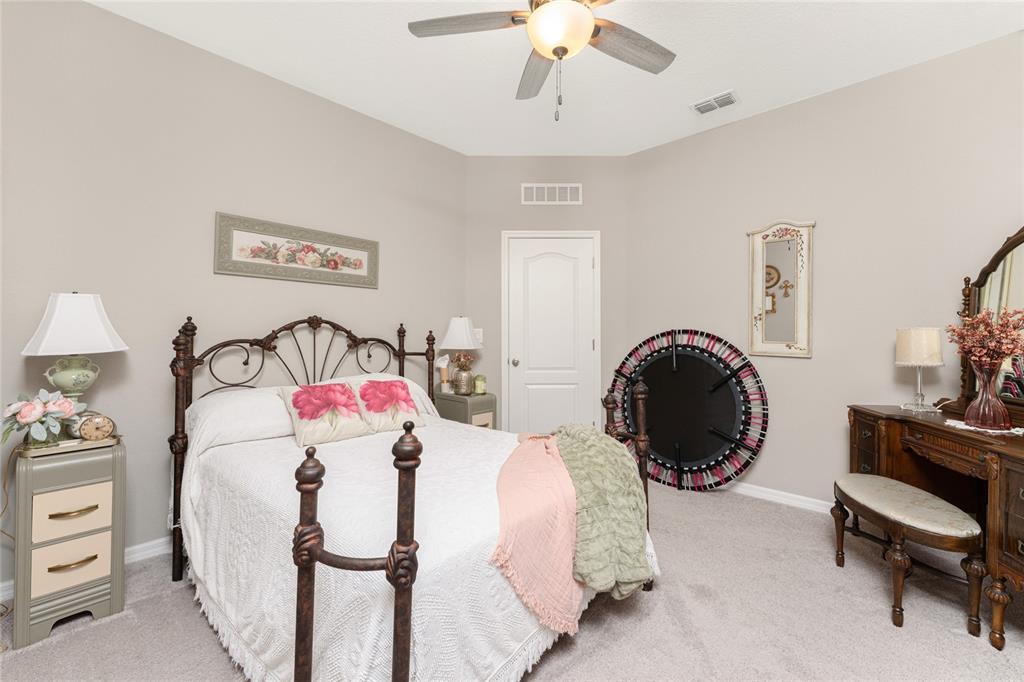 25381 Rupert Road Punta Gorda, FL 33983 - Photo 32 of 58 a bedroom with bed and a chandelier