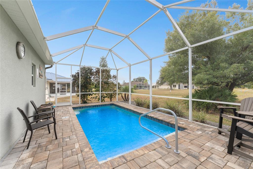 25381 Rupert Road Punta Gorda, FL 33983 - Photo 40 of 58 a view of a swimming pool with a lounge chair
