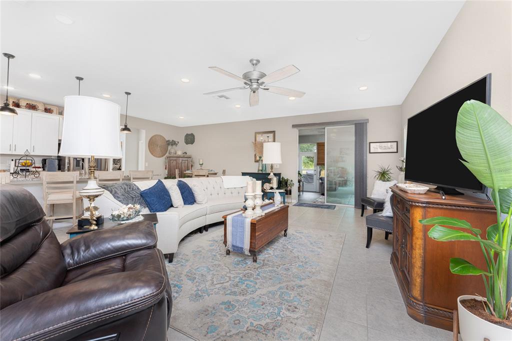 25381 Rupert Road Punta Gorda, FL 33983 - Photo 6 of 58 a living room with furniture a fireplace and a chandelier