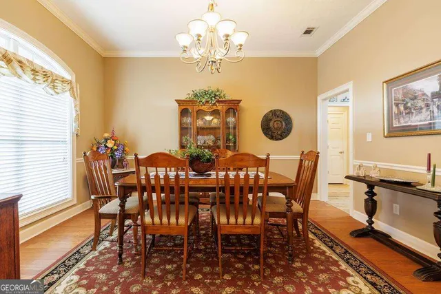a view of a dining room with furniture and chandelier