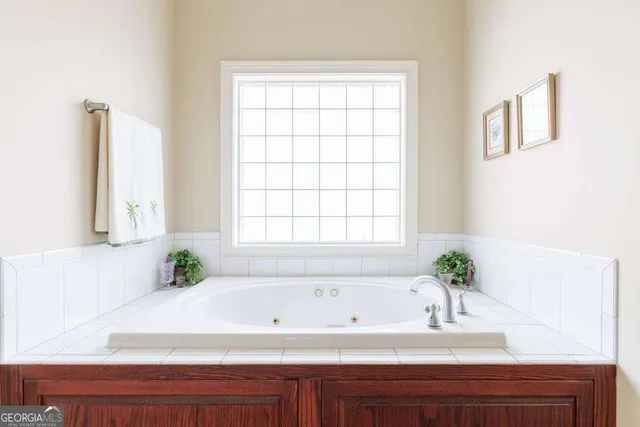 a bathroom with a bathtub and window