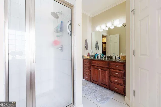 a bathroom with a granite countertop sink a mirror and a vanity