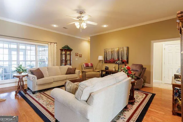 a living room with furniture and a chandelier