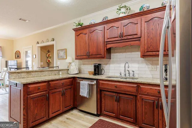 a kitchen with stainless steel appliances granite countertop a sink and cabinets