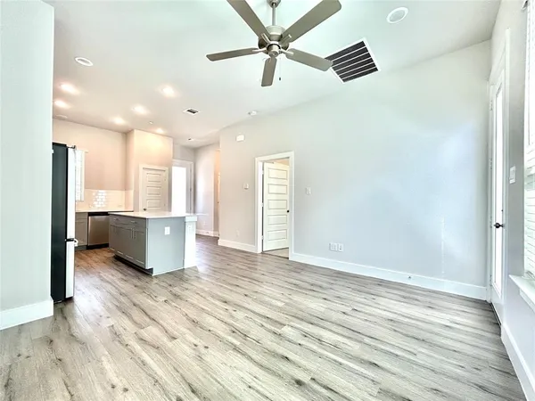 a kitchen with granite countertop white cabinets and stainless steel appliances