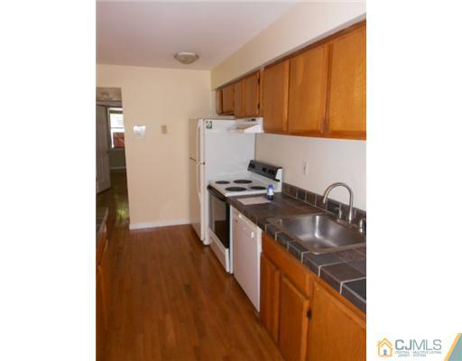 200 Portland Road, Unit D8 Highlands, NJ 07732 - Photo 6 of 10 a kitchen with stainless steel appliances granite countertop a stove a sink and a refrigerator