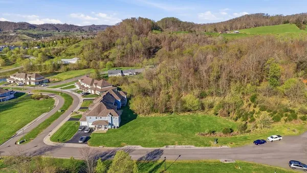 an aerial view of residential house with an outdoor space and seating
