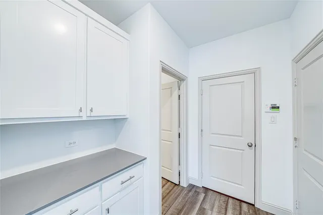 a kitchen with white cabinets and white appliances