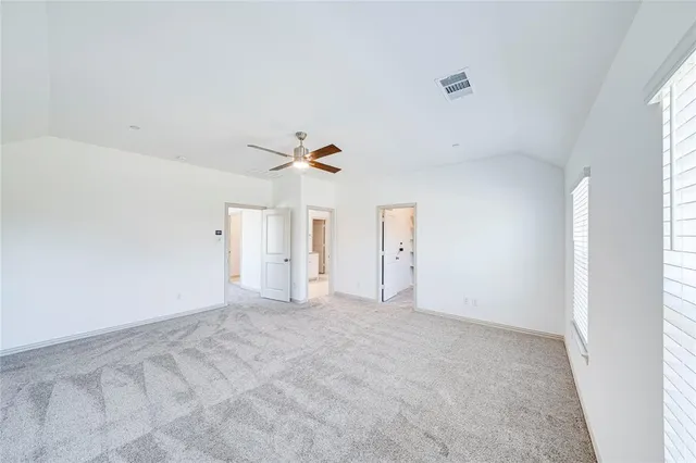 a view of a hallway with wooden floor and windows